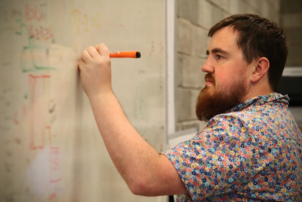 Sam Shelley writing on whiteboard